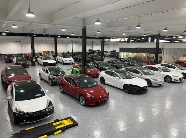 A large room filled with lots of cars.