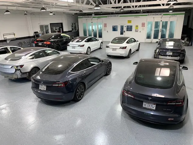 A group of cars parked in a showroom.