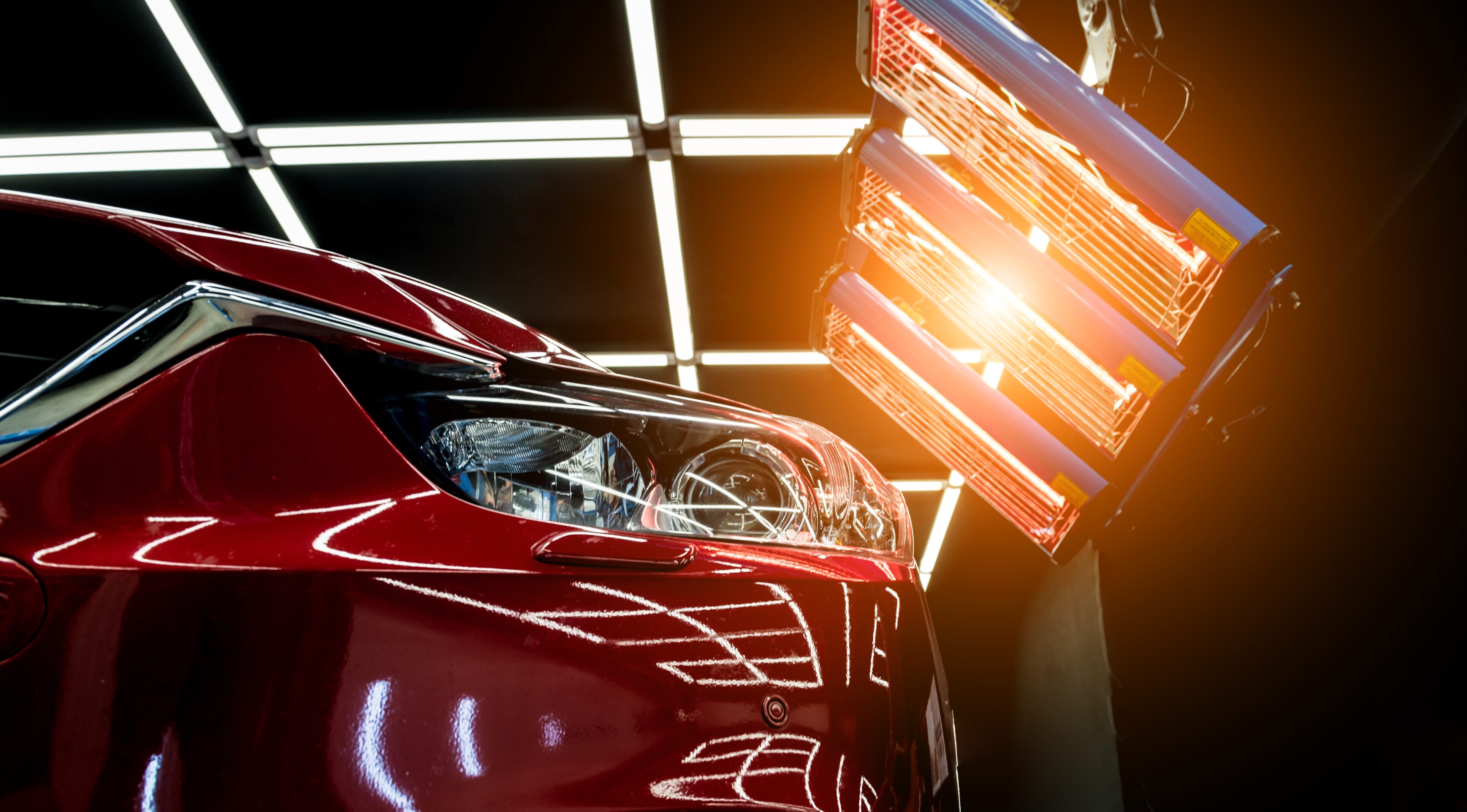 A red car is parked in the garage.