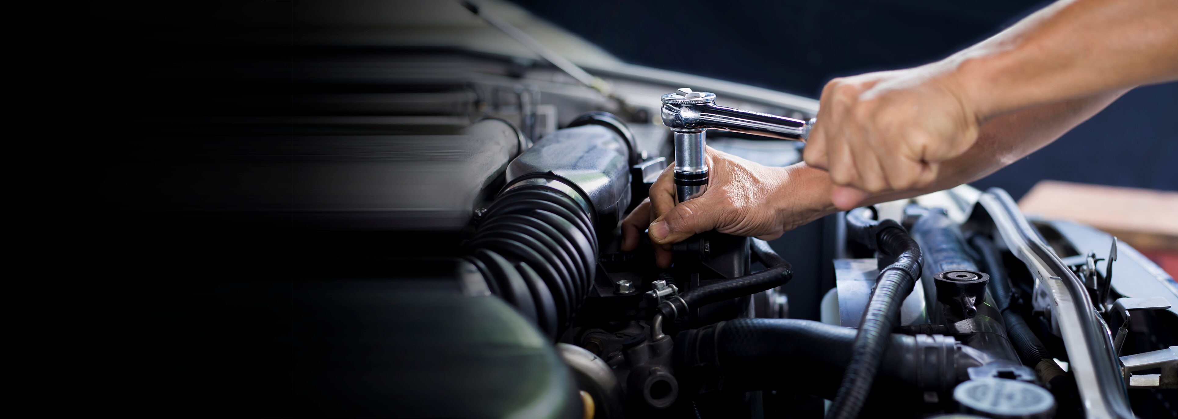 A person working on an engine in a garage.