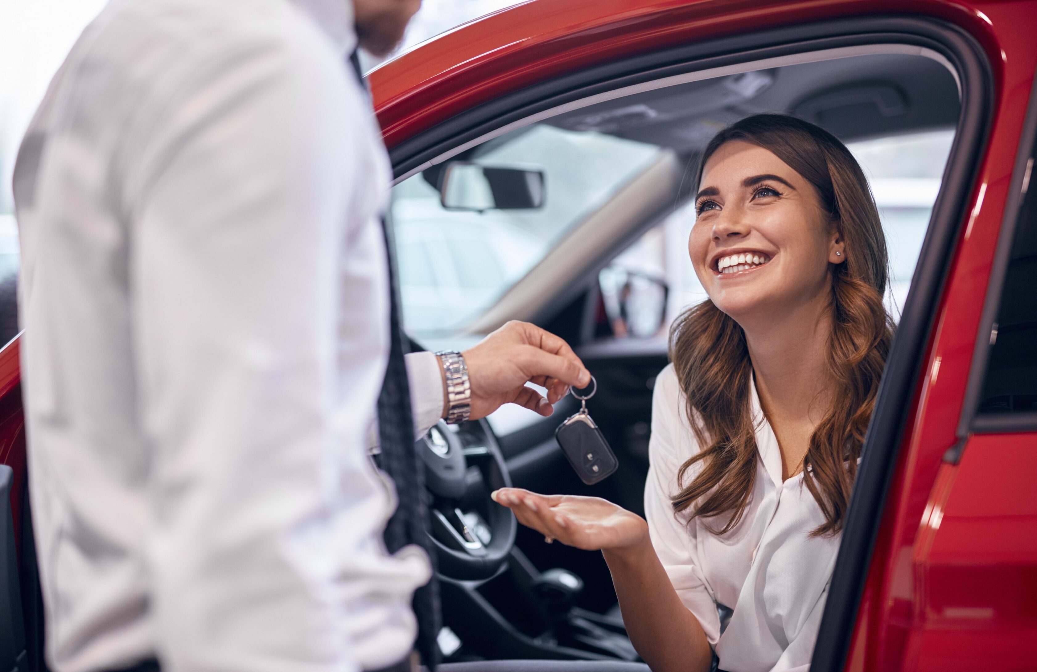 A woman sitting in the driver 's seat of a car.