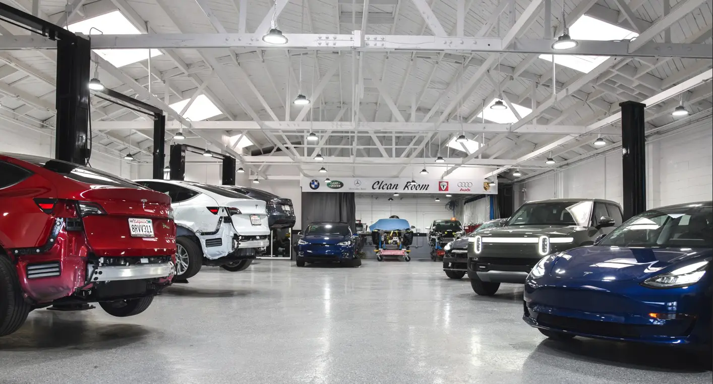 A car showroom with many cars parked in it.