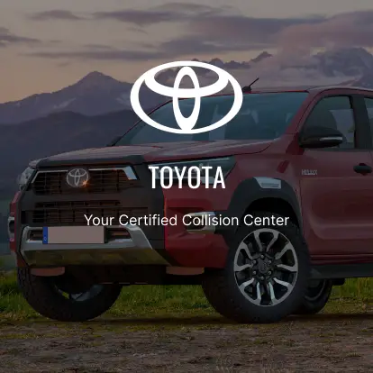 A red truck parked on top of a dirt field.